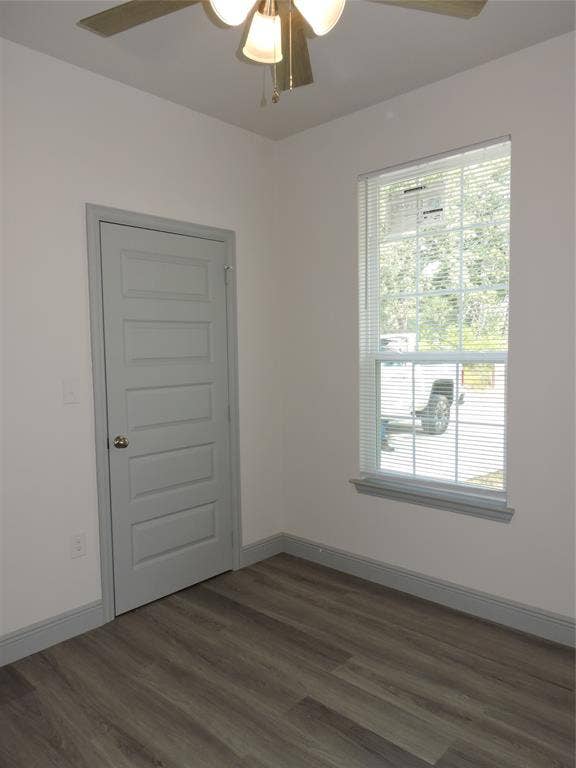 6110 Tejas Drive, Mabank, TX 75156 Interior room featuring wood-finish flooring, a neutral color palette, paneled door, window with blinds, and a ceiling fan with light fixture