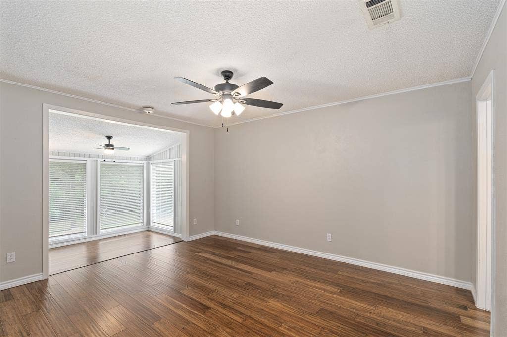 243 Shoreline Drive, Star Harbor, TX 75148 Spacious primary bedroom with bonus sitting area overlooking the channel to open water. Fully updated ensuite bath.