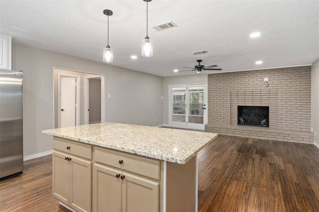 243 Shoreline Drive, Star Harbor, TX 75148 Large living room with wood burning fireplace opens out to the Sunroom and then out to the large deck.