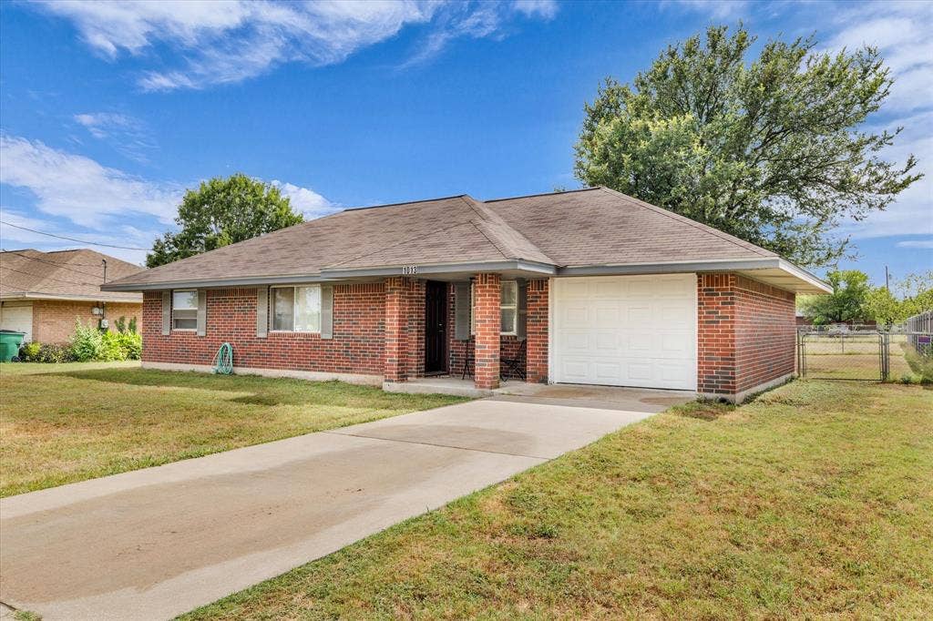 1013 S Madison Street, McGregor, TX 76657 Featuring a Concrete Drive and 1 Car Garage