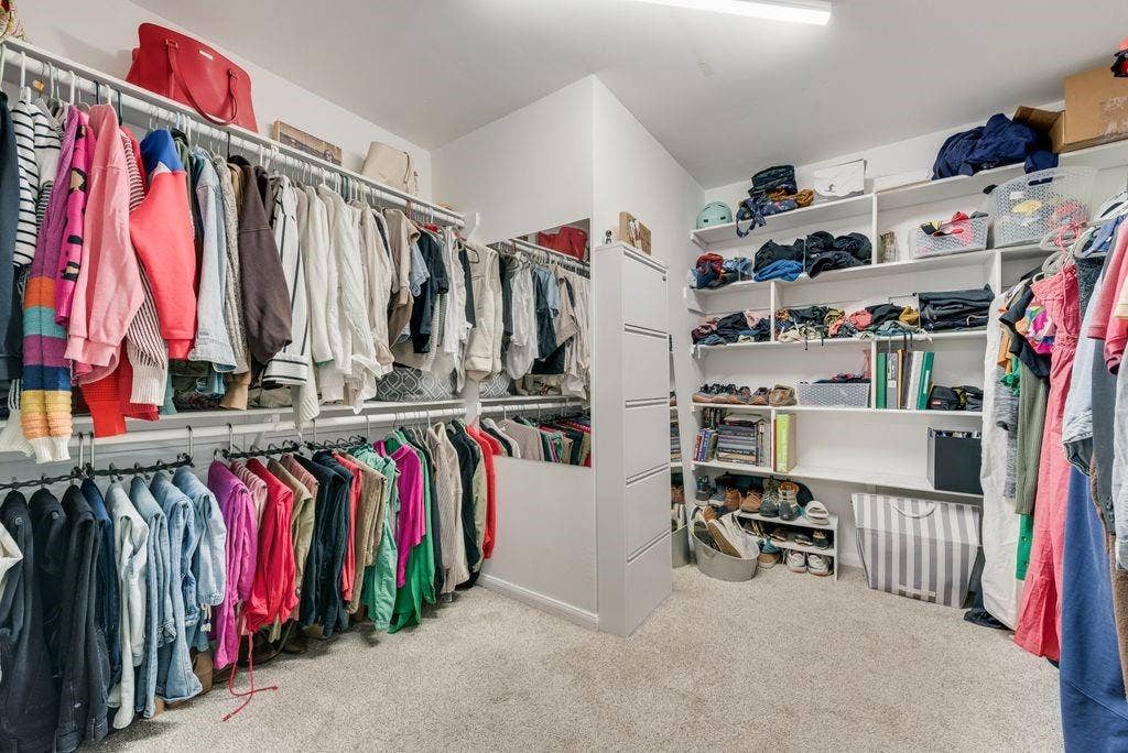 With a primary closet this large, you may need to buy more clothes.
