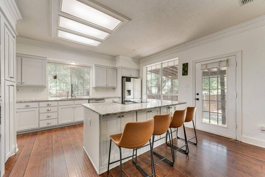 Kitchen was remodeled in 2016,  space was opened up,  cabinets, granite  & backsplash were replaced and stainless steel appliances were installed.
