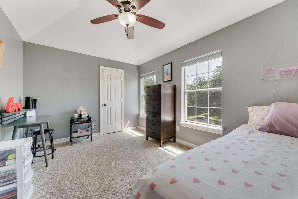 One of three secondary bedrooms, with a vaulted ceiling and a walk-in closet.