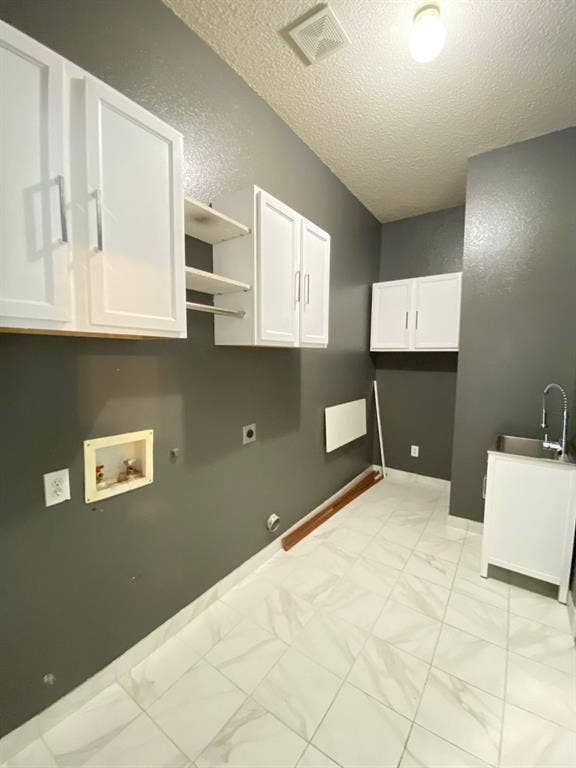 1328 Falcon Hollow, Cedar Hill, TX 75104 Utility room featuring white shaker-style cabinetry, open shelving, and a stainless steel utility sink with a high-arc faucet