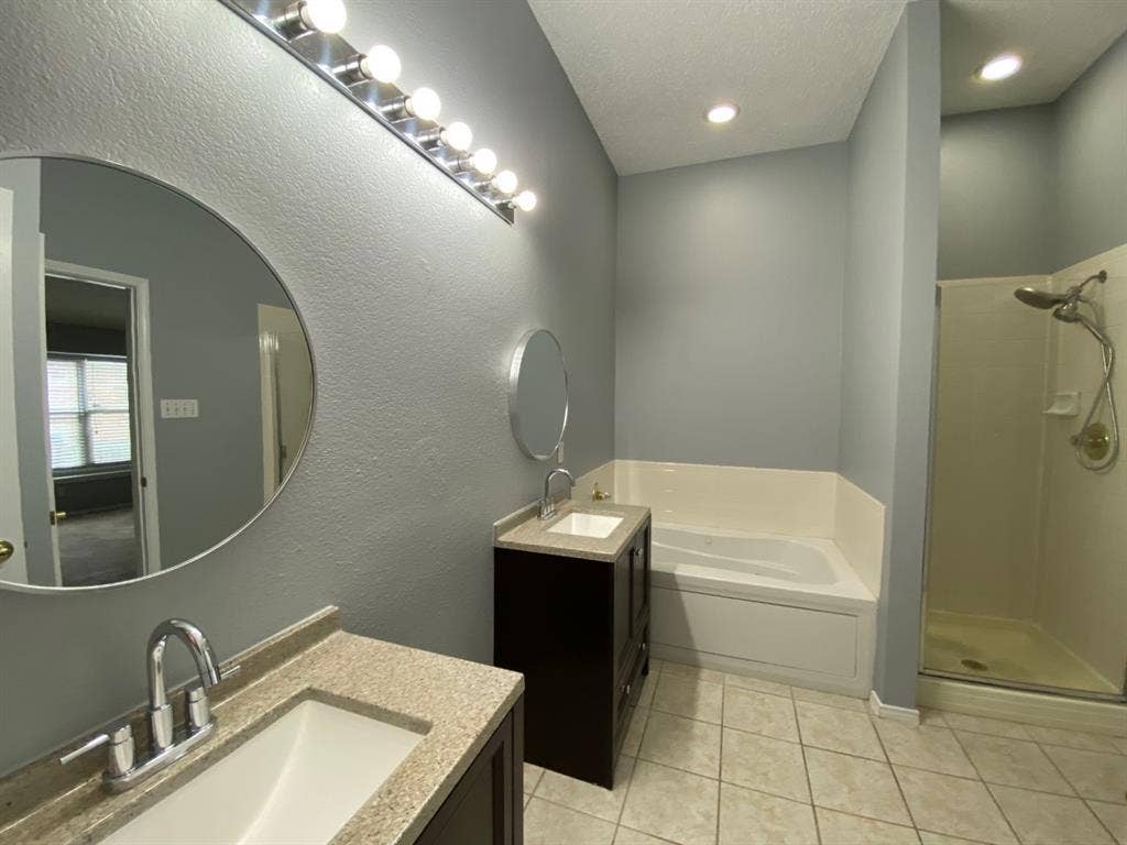 1328 Falcon Hollow, Cedar Hill, TX 75104 Bathroom featuring two vanity sinks, a built-in tub, a glass-enclosed shower, and tile flooring