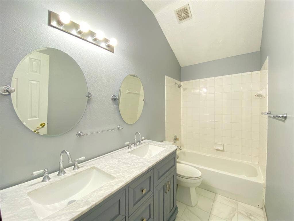 1328 Falcon Hollow, Cedar Hill, TX 75104 Bathroom featuring a dual vanity with a patterned countertop, undermount sinks, and chrome faucets