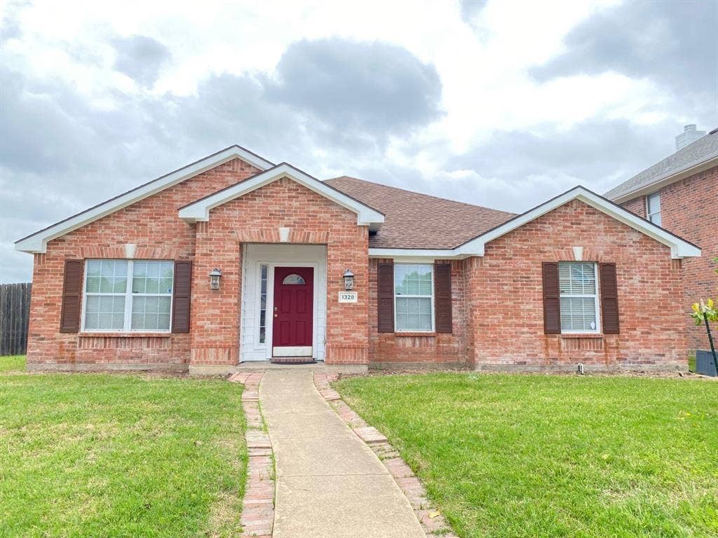 1328 Falcon Hollow, Cedar Hill, TX 75104 Brick exterior featuring a gabled roofline, decorative window shutters, and a prominent red front door