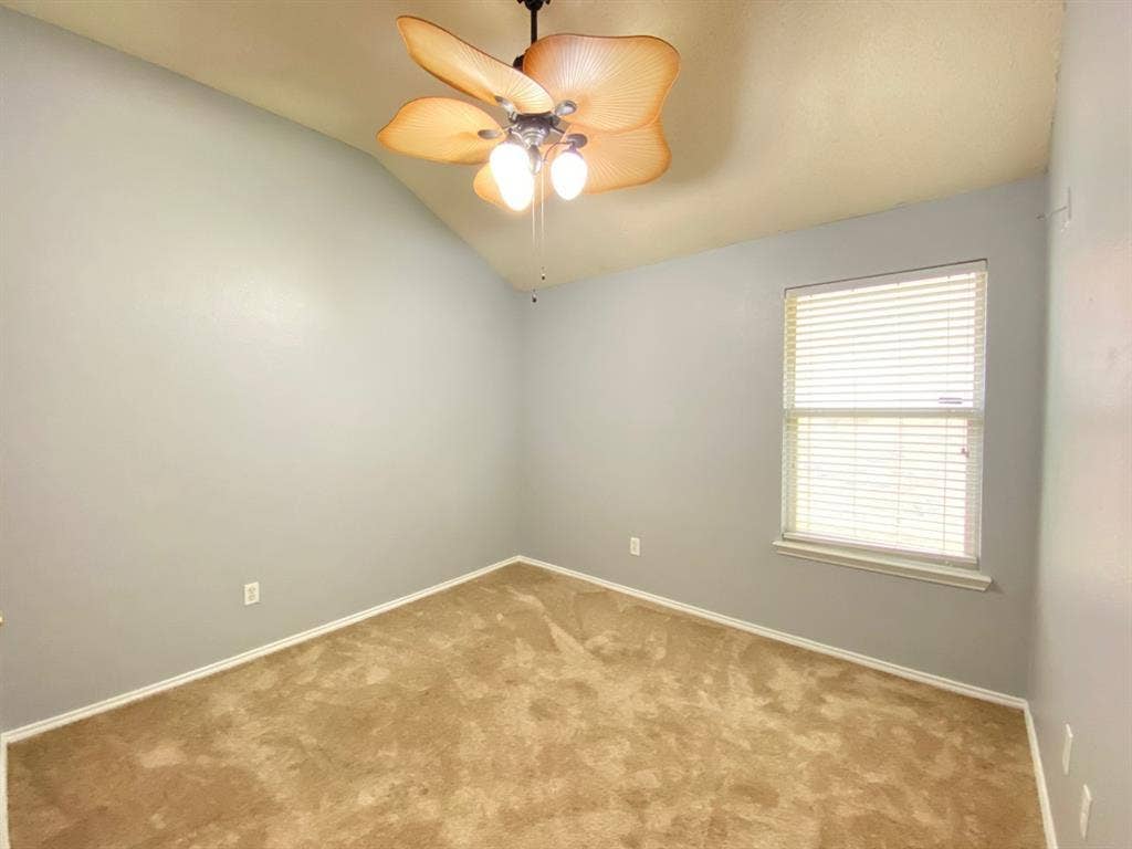 1328 Falcon Hollow, Cedar Hill, TX 75104 Room featuring neutral-toned carpeting, light gray walls, and a vaulted ceiling