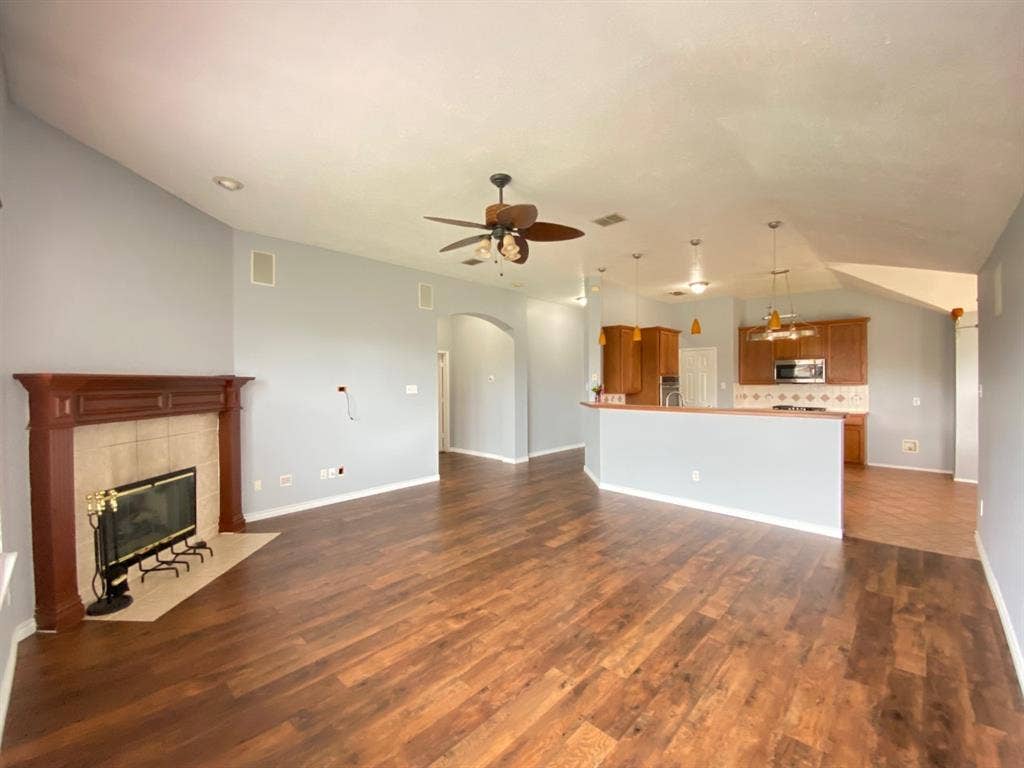 1328 Falcon Hollow, Cedar Hill, TX 75104 Spacious interior featuring wood-finish flooring, a fireplace with a tiled surround, a ceiling fan, and recessed lighting