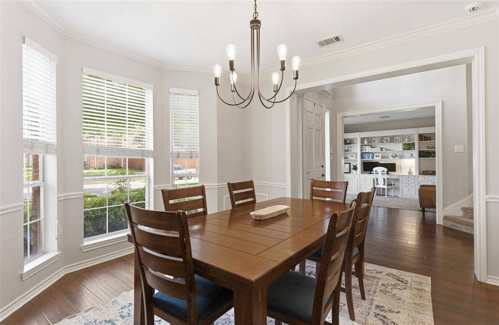 4112 Blackpool Drive, Plano, TX 75093 Formal dining area featuring bay windows with blinds, crown molding, and wood-finish flooring