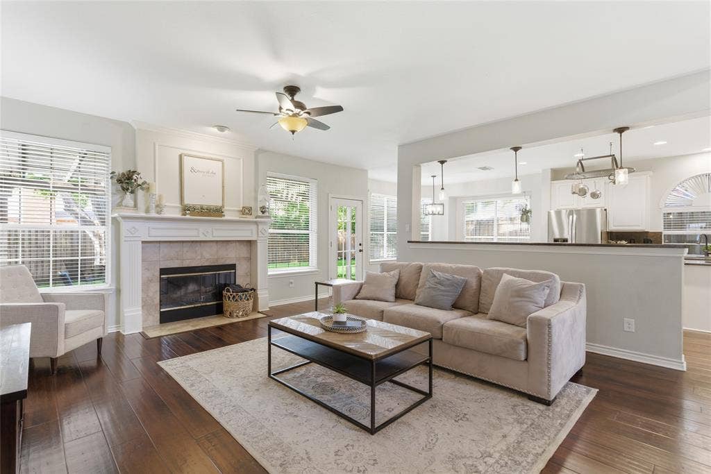 4112 Blackpool Drive, Plano, TX 75093 Living area featuring wood-finish flooring, a decorative fireplace with a tile surround and mantel, and white interior trim