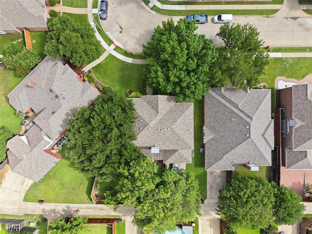 4112 Blackpool Drive, Plano, TX 75093 Aerial perspective showcasing a residential property with a shingle roof and surrounding green landscaping