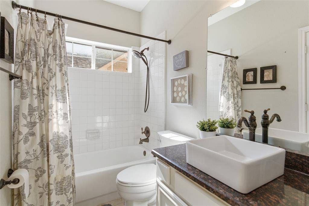 4112 Blackpool Drive, Plano, TX 75093 Bathroom vanity with a rectangular vessel sink, oil-rubbed bronze fixtures, and a dark stone countertop