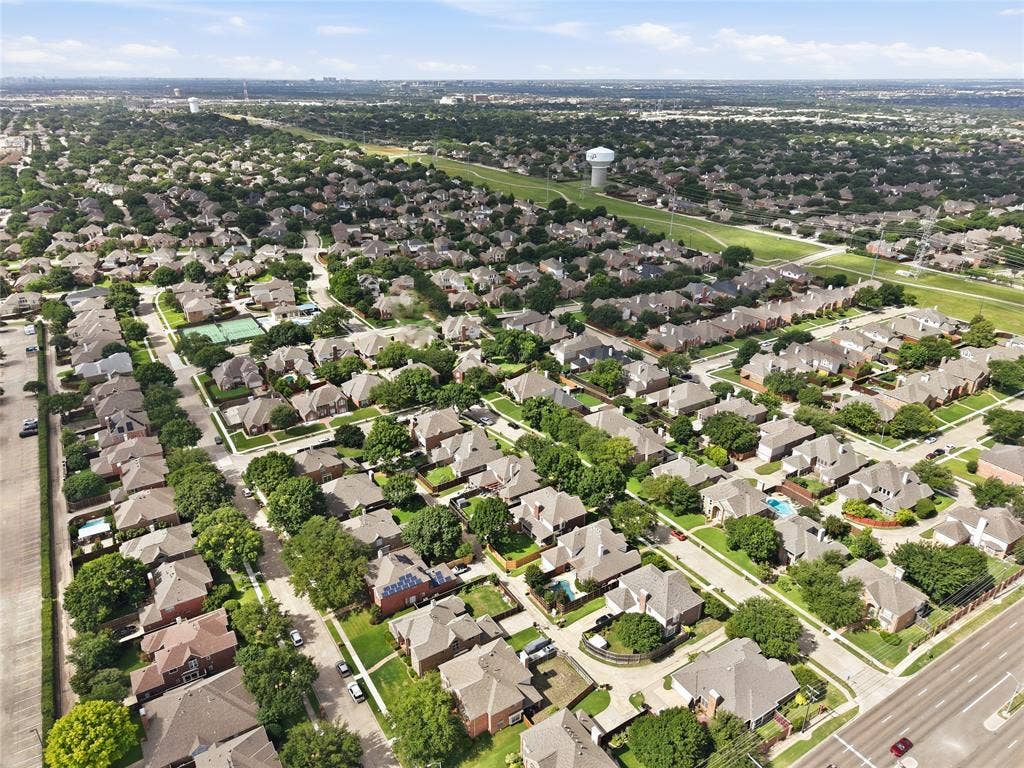 4112 Blackpool Drive, Plano, TX 75093 Aerial perspective showcasing a residential neighborhood with tree-lined streets, numerous single-family homes, and established landscaping