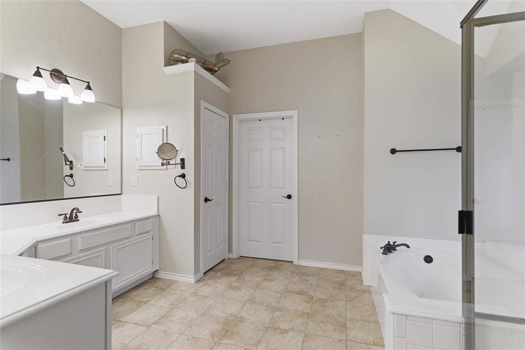 4112 Blackpool Drive, Plano, TX 75093 Bathroom featuring a large vanity with ample countertop space, a built-in tub, a separate shower enclosure, and tiled flooring