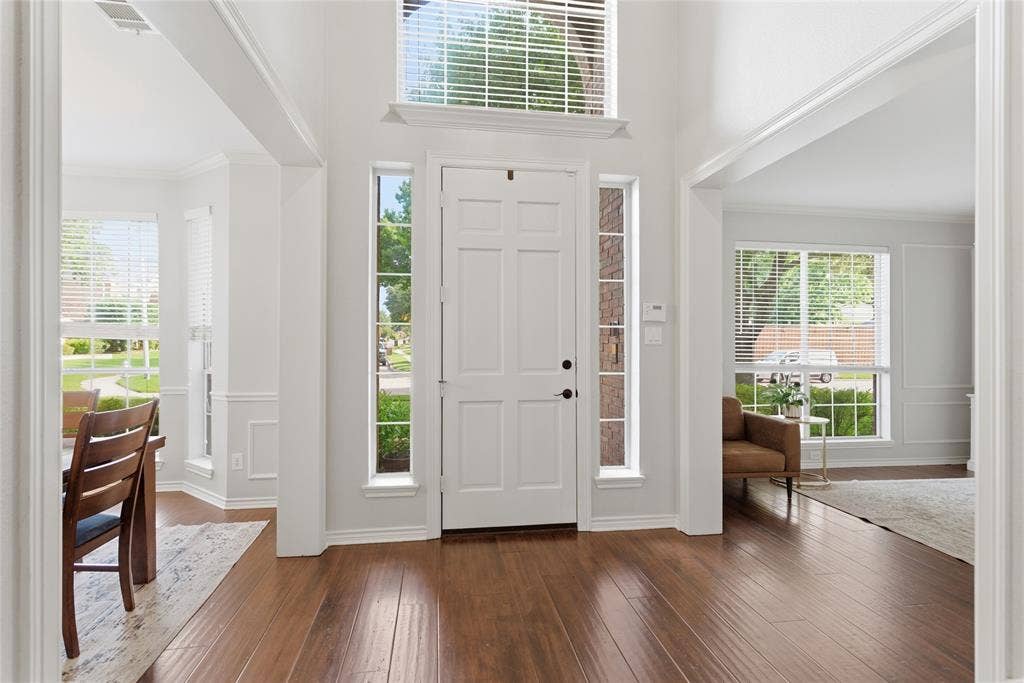 4112 Blackpool Drive, Plano, TX 75093 Entryway featuring wood-finish flooring, a paneled front door with side lite windows, and an overhead transom window