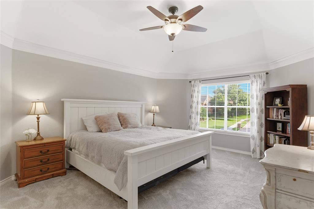 4112 Blackpool Drive, Plano, TX 75093 Spacious room featuring vaulted ceilings, crown molding, a large window with blinds, carpeted flooring, and a built-in ceiling fan with lighting
