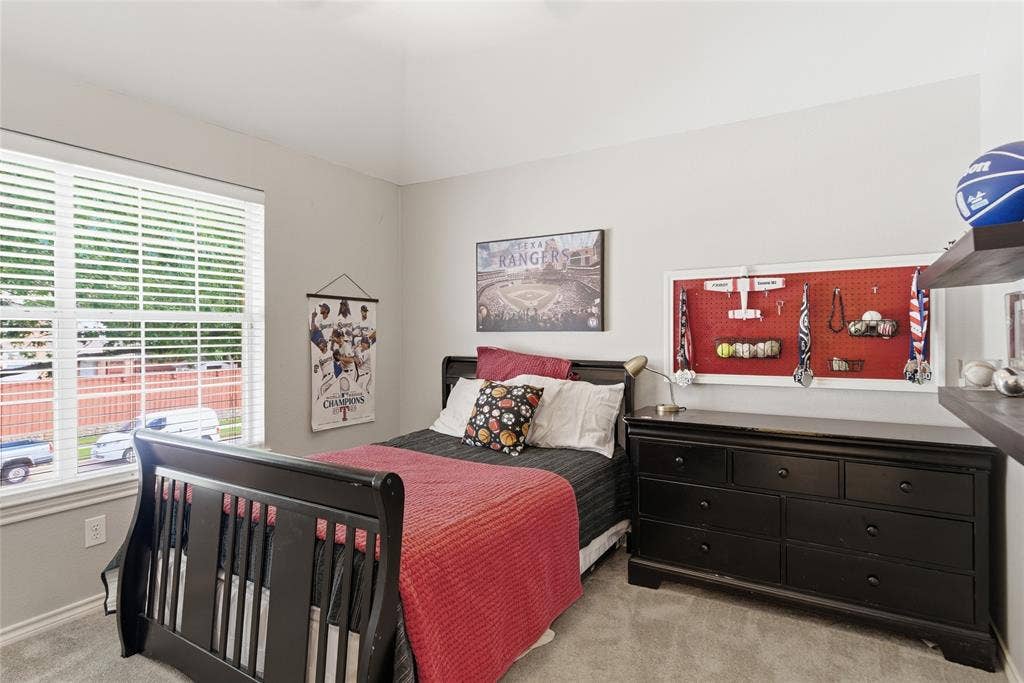 4112 Blackpool Drive, Plano, TX 75093 Carpeted room featuring a large window with blinds, light gray walls, and a vaulted ceiling