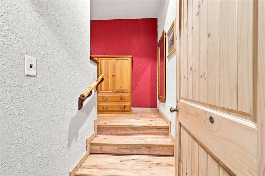 Hallway to the hall bath and bedrooms. Two storage closets in the hallway.
