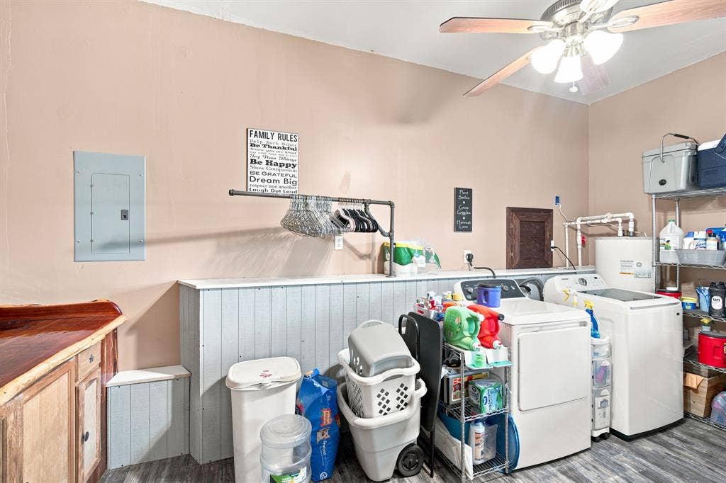 Laundry room is just off the kitchen. Lots of storage area including a folding or work table with starage and a wall of cabinets for pantry storage. Laundry room has a door out to the back deck area.