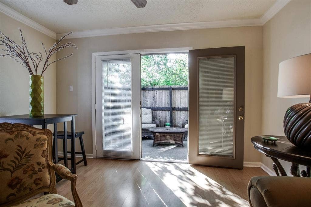 5322 Columbia Avenue, Dallas, TX 75214 Bright living room with a comfortable chair and a patio door that invites natural light and outdoor view.