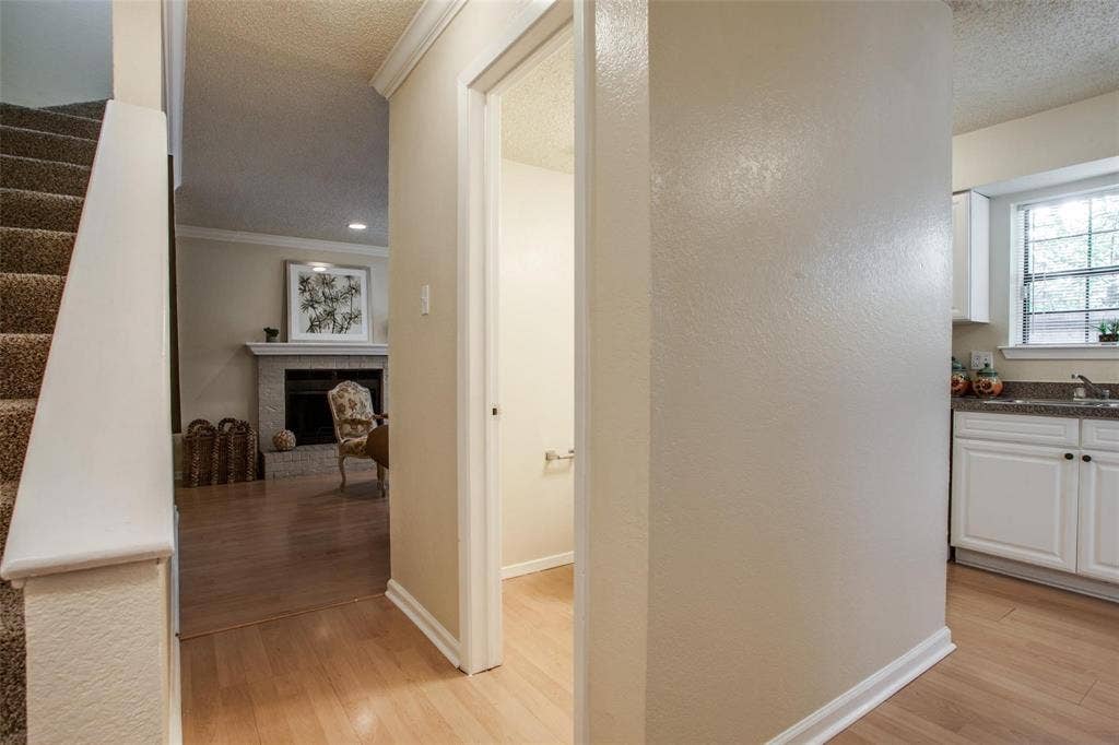 5322 Columbia Avenue, Dallas, TX 75214 Bright hallway that connects the staircase, living room, half bathroom and kitchen.