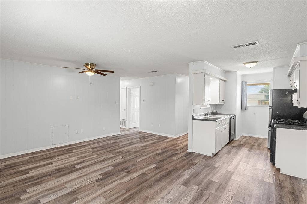 3407 Highmeadow Lane, Greenville, TX 75402 Open-concept living area featuring wood-finish flooring and a ceiling fan