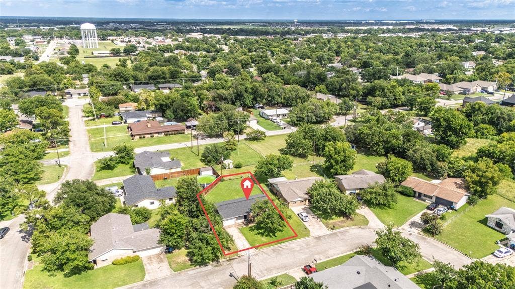 3407 Highmeadow Lane, Greenville, TX 75402 Aerial perspective highlighting a single-story residence with a dark shingle roof and a concrete driveway