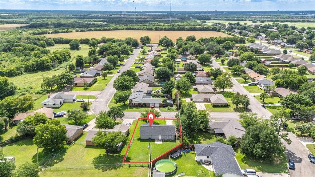 3407 Highmeadow Lane, Greenville, TX 75402 Aerial view of a residential neighborhood with a suburban street layout