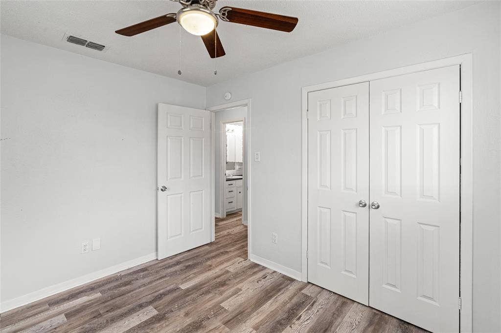3407 Highmeadow Lane, Greenville, TX 75402 Room featuring wood-finish flooring, a ceiling fan with integrated lighting, and white walls