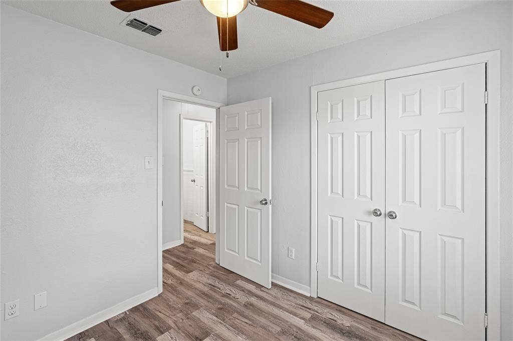 3407 Highmeadow Lane, Greenville, TX 75402 Interior space featuring wood-finish flooring, light grey wall paint, and white trim