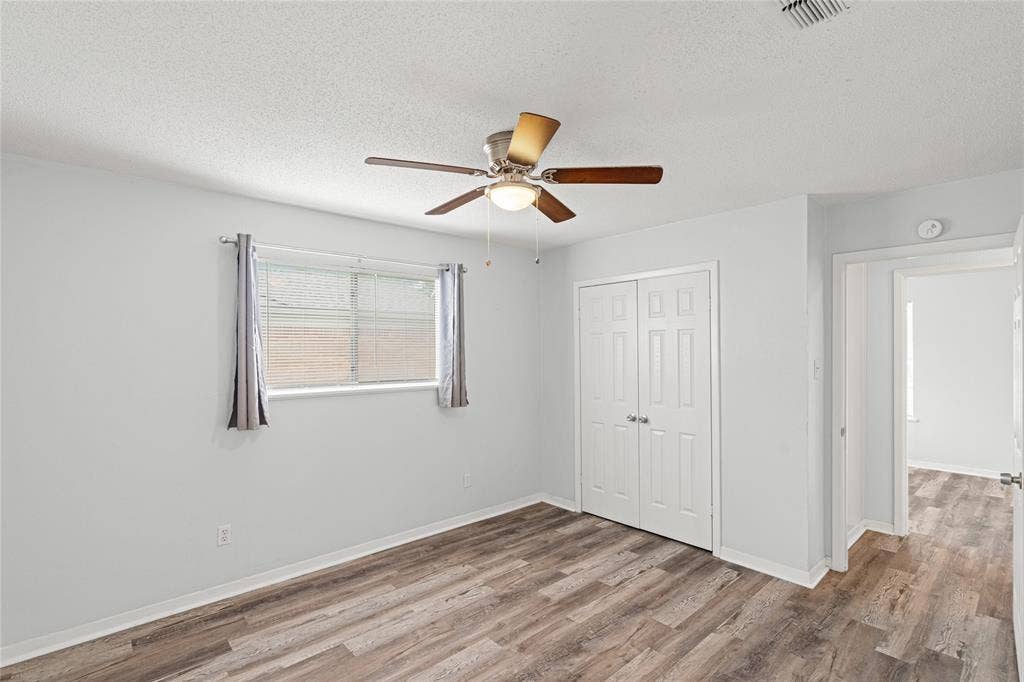 3407 Highmeadow Lane, Greenville, TX 75402 Bright room featuring wood-finish flooring and light-toned walls