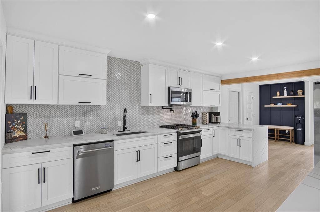 4064 High Summit Drive, Dallas, TX 75244 Kitchen has gas range and quartz counters.