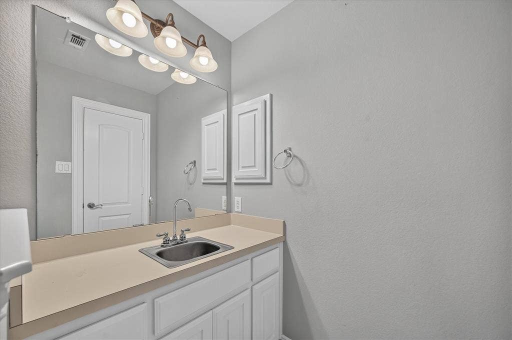 8405 Gallery Way, McKinney, TX 75072 Bathroom vanity featuring a stainless steel sink, chrome faucet, and expansive mirror