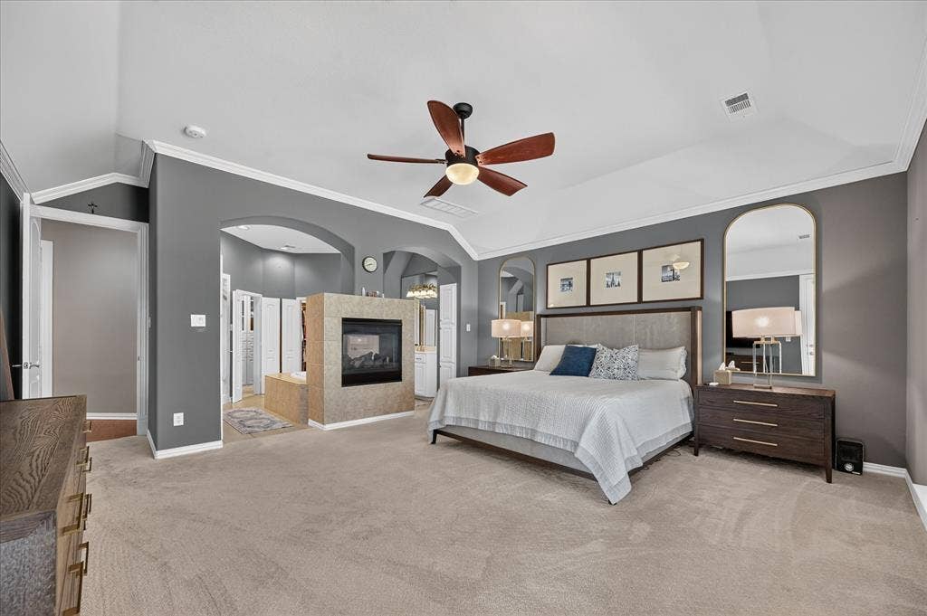 8405 Gallery Way, McKinney, TX 75072 Expansive carpeted room featuring a ceiling fan, vaulted ceiling, and an arched entry