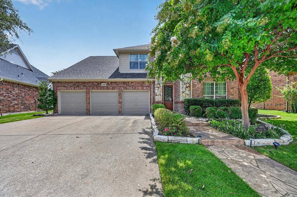 8405 Gallery Way, McKinney, TX 75072 Brick and siding exterior featuring a three-car garage and a concrete driveway
