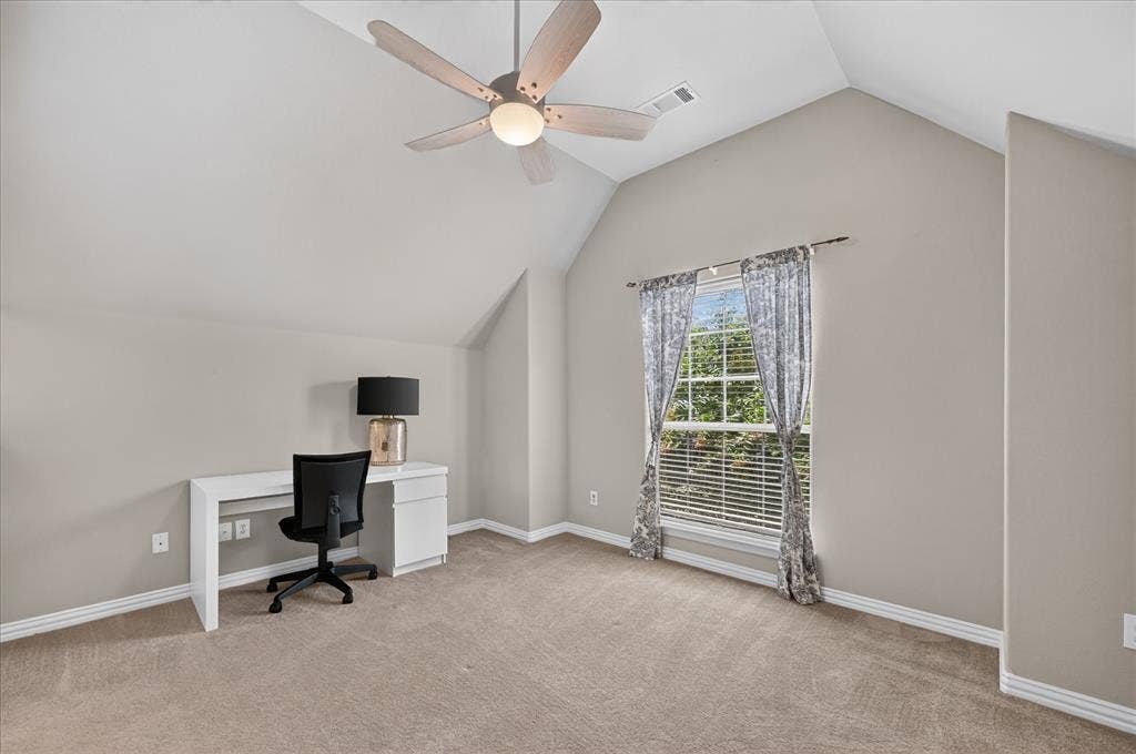 8405 Gallery Way, McKinney, TX 75072 Spacious room featuring vaulted ceilings, neutral-toned carpeting, a large window with blinds, and a ceiling fan with integrated lighting