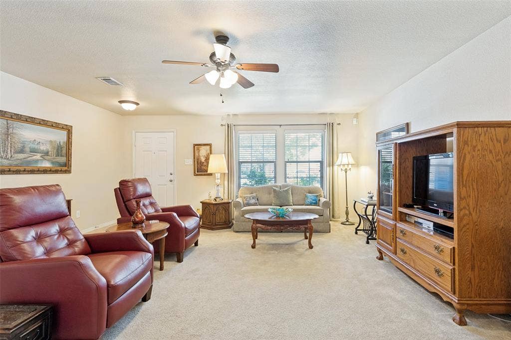 317 Amethyst Drive, Fort Worth, TX 76131 Spacious living room featuring a ceiling fan with integrated lighting, recessed lighting, and a front entry door with decorative glass inserts