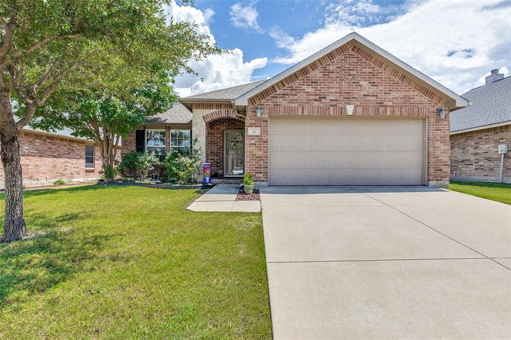 317 Amethyst Drive, Fort Worth, TX 76131 Brick exterior featuring a two-car garage, concrete driveway, and covered entry