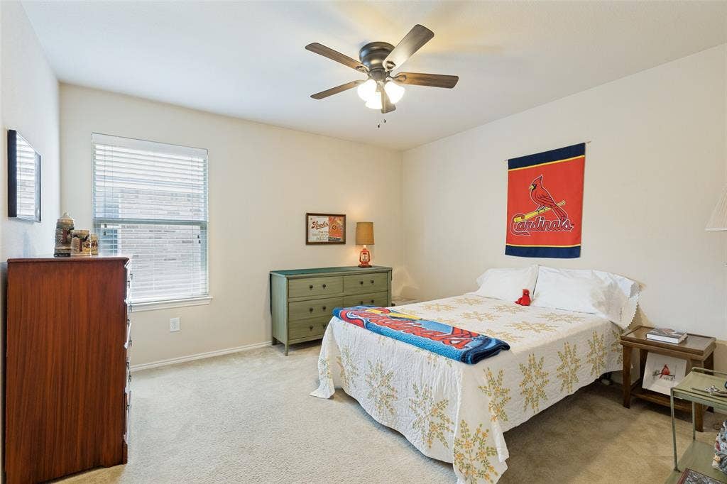 317 Amethyst Drive, Fort Worth, TX 76131 Carpeted room featuring a ceiling fan with integrated lighting, a window with horizontal blinds, and neutral wall paint