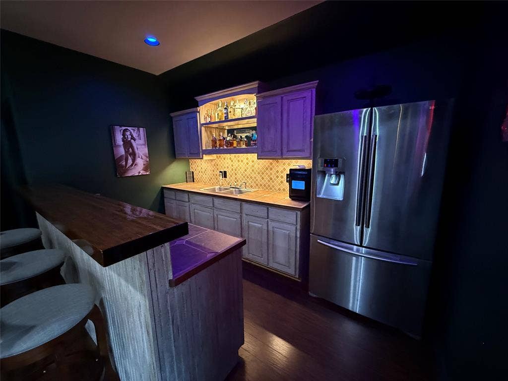 8040 Branch Hollow Trail, Fort Worth, TX 76123 Accent lighting in bar! Guess what's behind the Rita Hayworth poster? A safe! Reminiscent of a movie you may know?