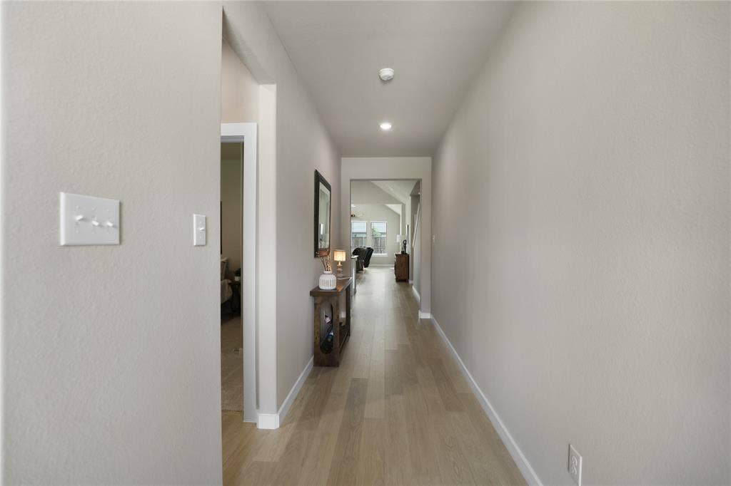 919 Edgehurst Drive, Princeton, TX 75071 Hallway featuring light-toned wood-finish flooring, recessed lighting, and neutral wall paint