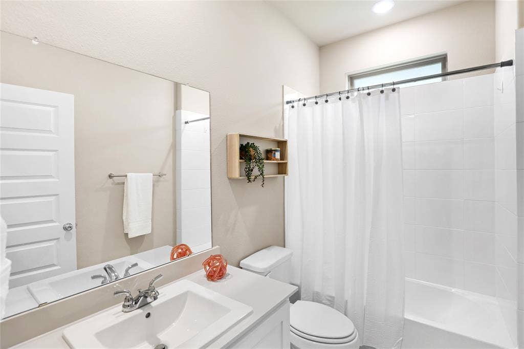 919 Edgehurst Drive, Princeton, TX 75071 Bathroom featuring a single vanity with an integrated sink and chrome fixtures