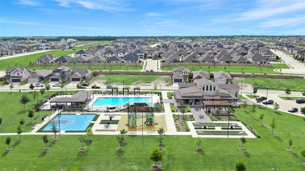 919 Edgehurst Drive, Princeton, TX 75071 Community clubhouse and amenity center featuring a swimming pool, basketball court, and green spaces