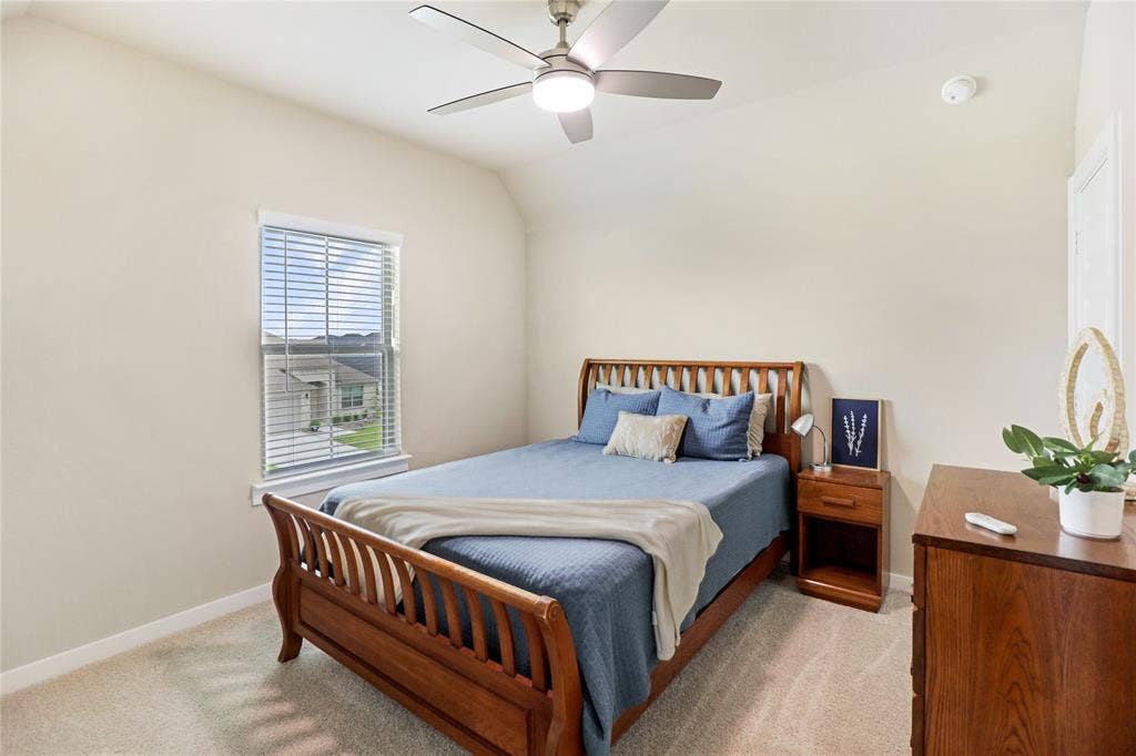 919 Edgehurst Drive, Princeton, TX 75071 Carpeted bedroom featuring a ceiling fan with integrated lighting, a window with horizontal blinds, and neutral wall tones