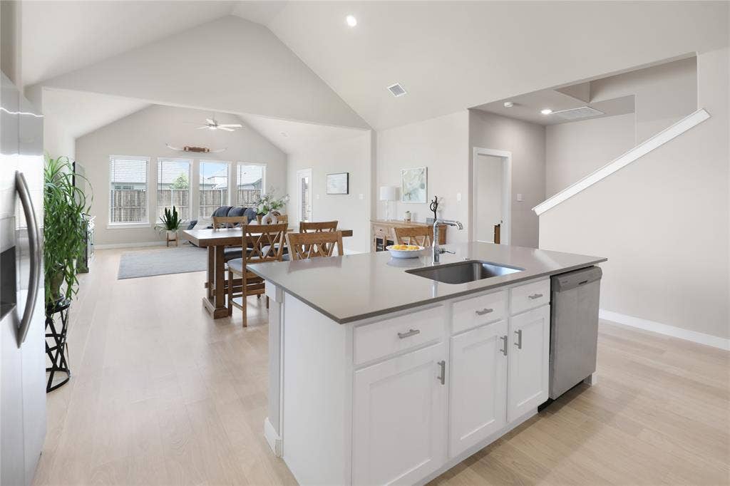 919 Edgehurst Drive, Princeton, TX 75071 Central kitchen island featuring a stainless steel sink, ample cabinetry, and a built-in dishwasher