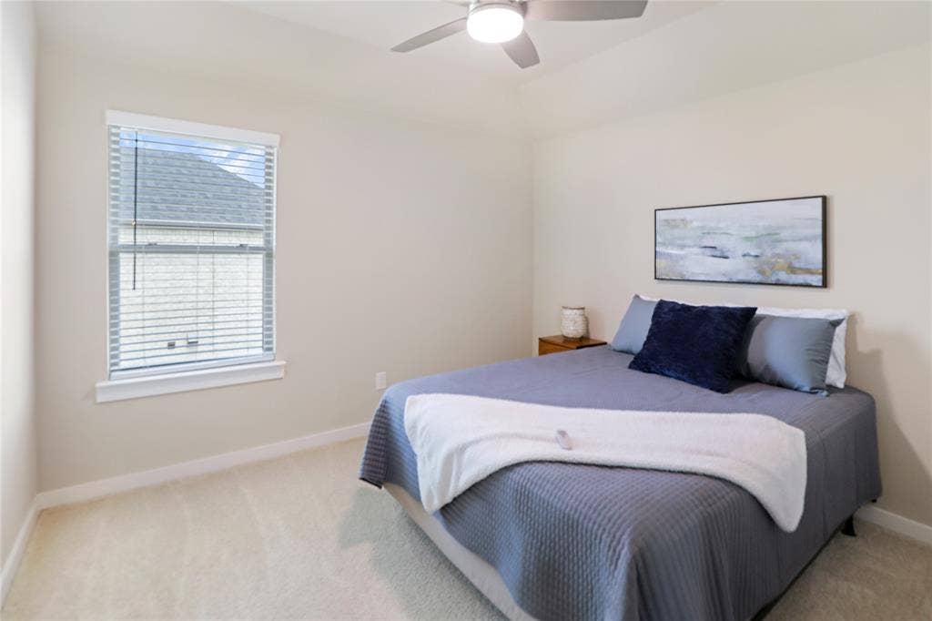919 Edgehurst Drive, Princeton, TX 75071 Bedroom featuring a vaulted ceiling with a ceiling fan, a single window with blinds, light-toned walls, and carpet flooring