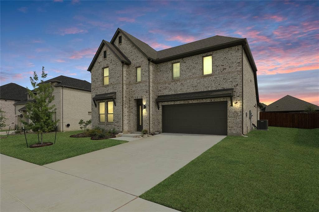 919 Edgehurst Drive, Princeton, TX 75071 Two-story brick facade residence featuring an attached garage, covered entryway, and a concrete driveway