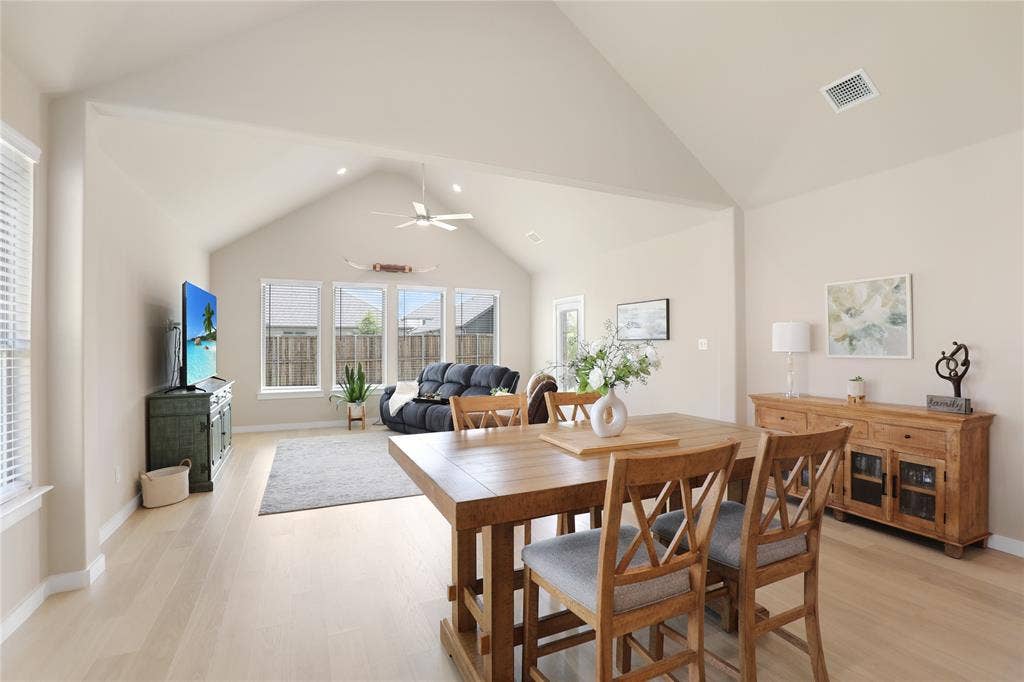 919 Edgehurst Drive, Princeton, TX 75071 Vaulted ceilings highlight the open-concept living space, featuring light wood-finish flooring and recessed lighting