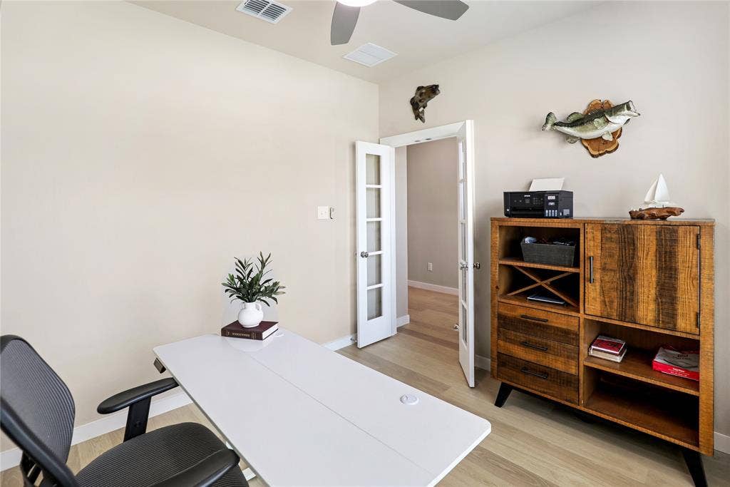919 Edgehurst Drive, Princeton, TX 75071 Room featuring light-toned walls, wood-finish flooring, a ceiling fan, and double French doors with frosted glass panels